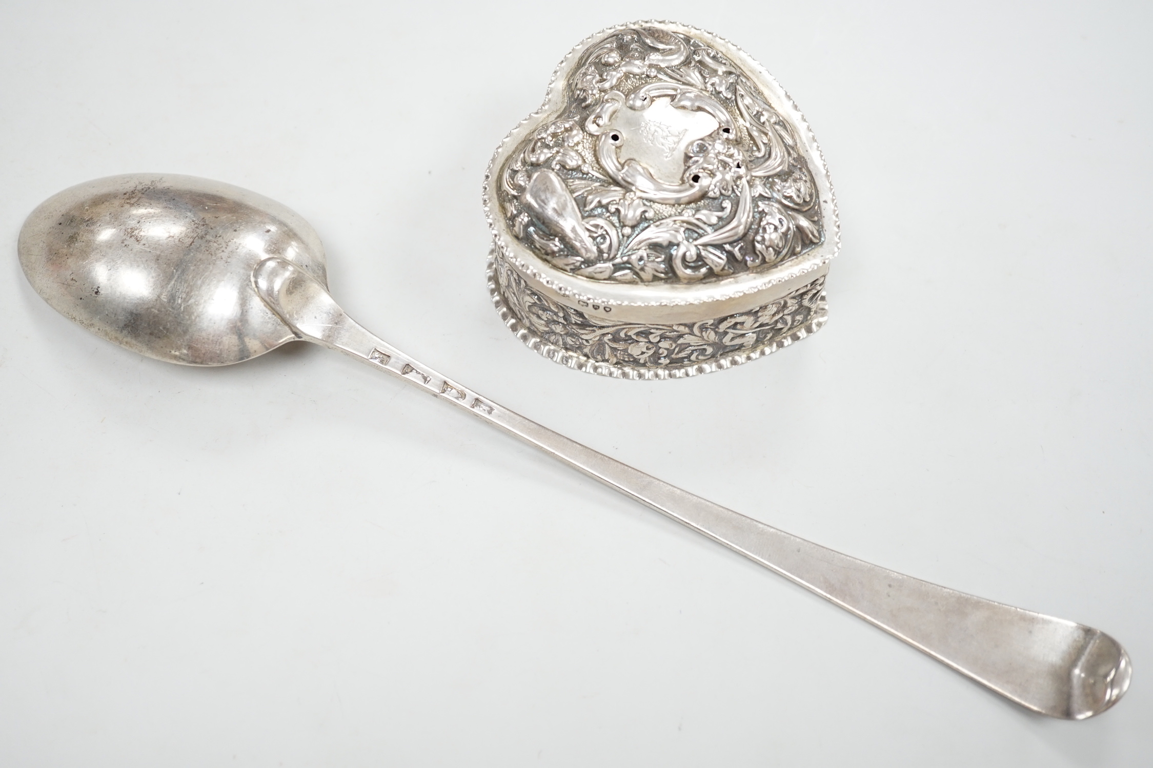 A George III silver Old English pattern bright cut engraved silver basting spoon, Sumner & Crossley, London, 1776 and a later repousse heart shaped trinket box.